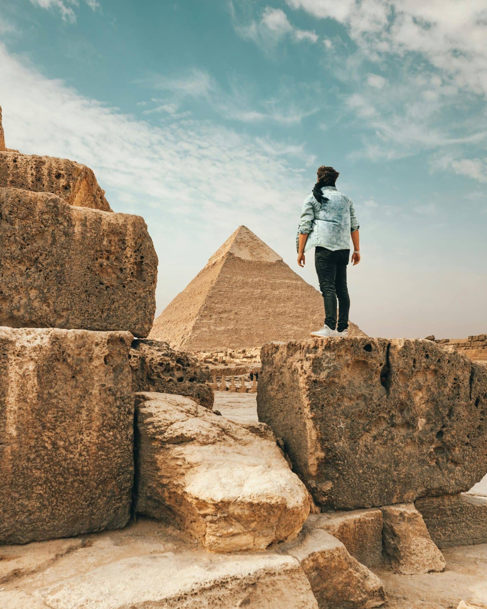 a man taking photo in front of the Pyramid